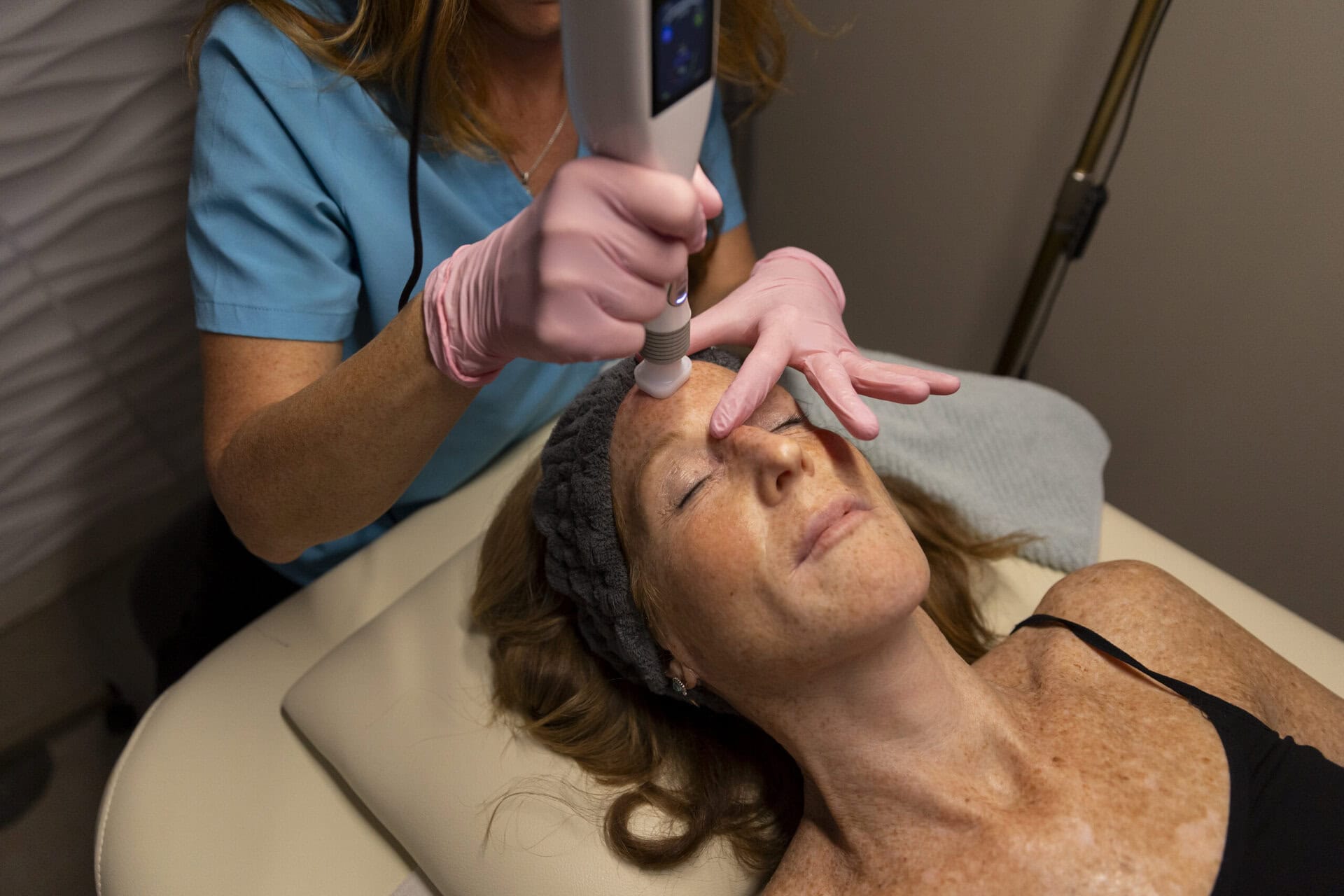 Microneedling facial treatment with a radiofrequency device at wellness clinic in MA for skin rejuvenation and anti-aging.