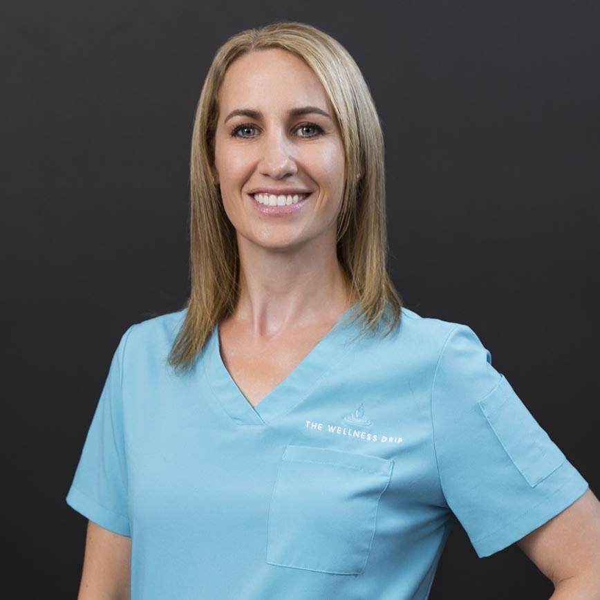 Natural wellness clinic professional in blue scrubs providing IV therapy for health and recovery in Holyoke MA.