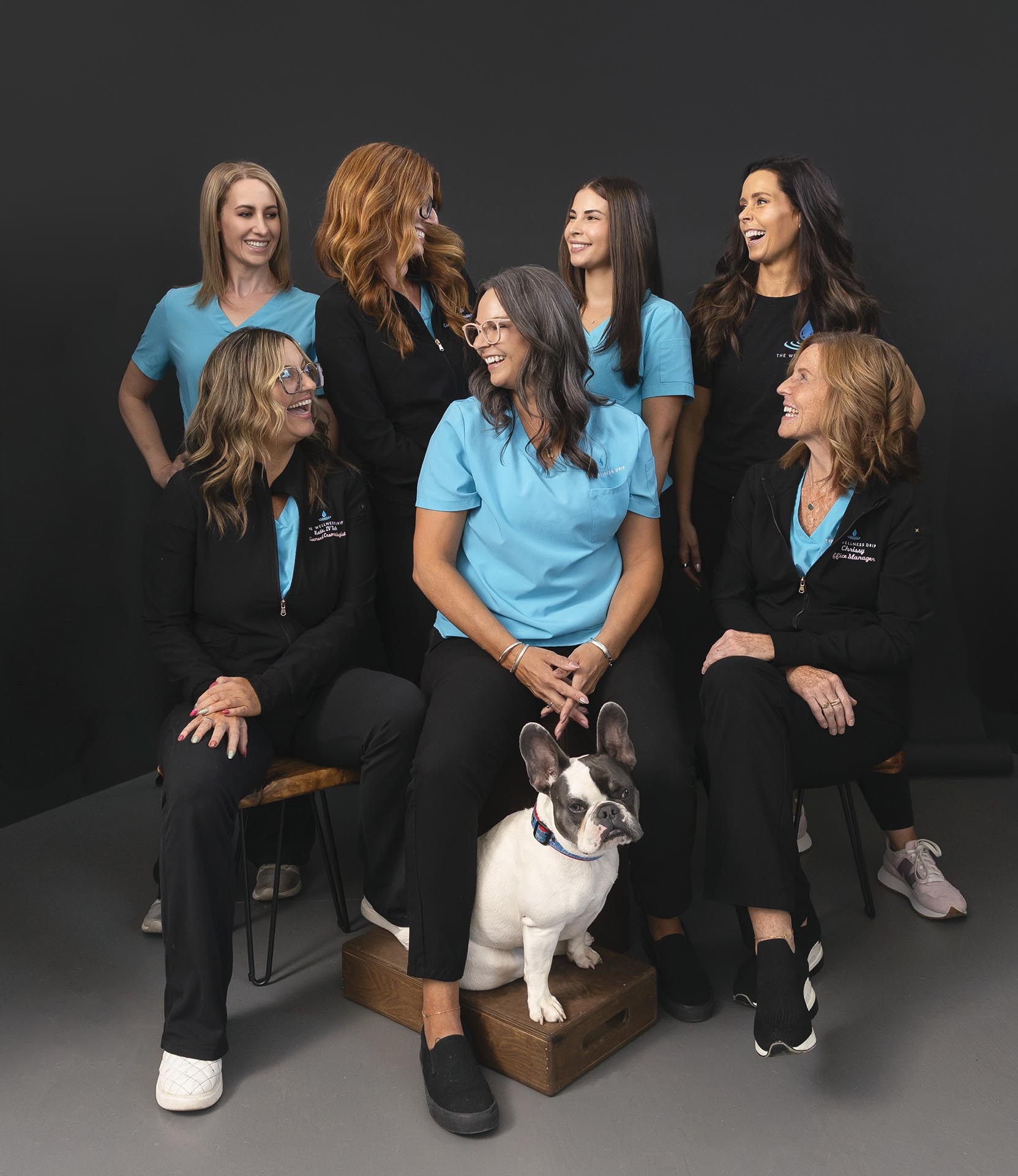 Friendly wellness clinic team in MA healthcare uniforms smiling with dog, promoting ketamine therapy, weight loss, NAD+, ozone, vitamin infusions, chronic pain, anxiety, depression treatments, MA.
