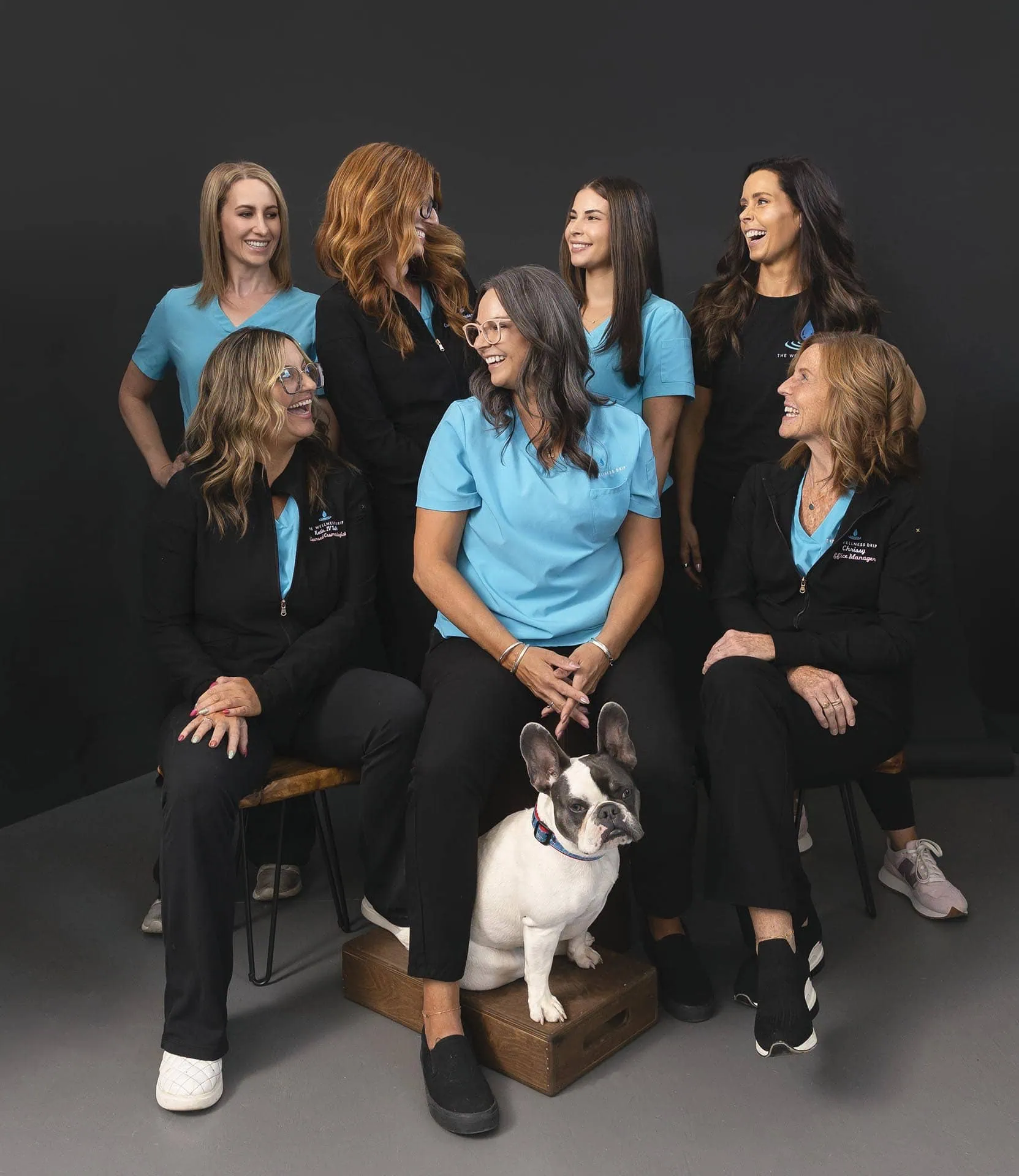 Friendly wellness clinic team in MA healthcare uniforms smiling with dog, promoting ketamine therapy, weight loss, NAD+, ozone, vitamin infusions, chronic pain, anxiety, depression treatments, MA.