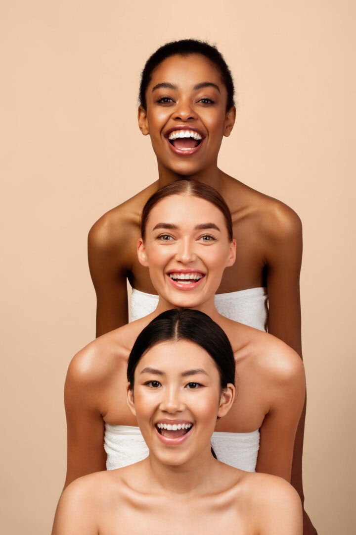 Healthy diverse women smiling with wellness spa towels, promoting relaxation, self-care, and holistic health benefits.