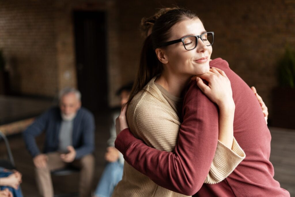 Relaxed woman receiving emotional support during wellness therapy session at The Wellness Drip INC.