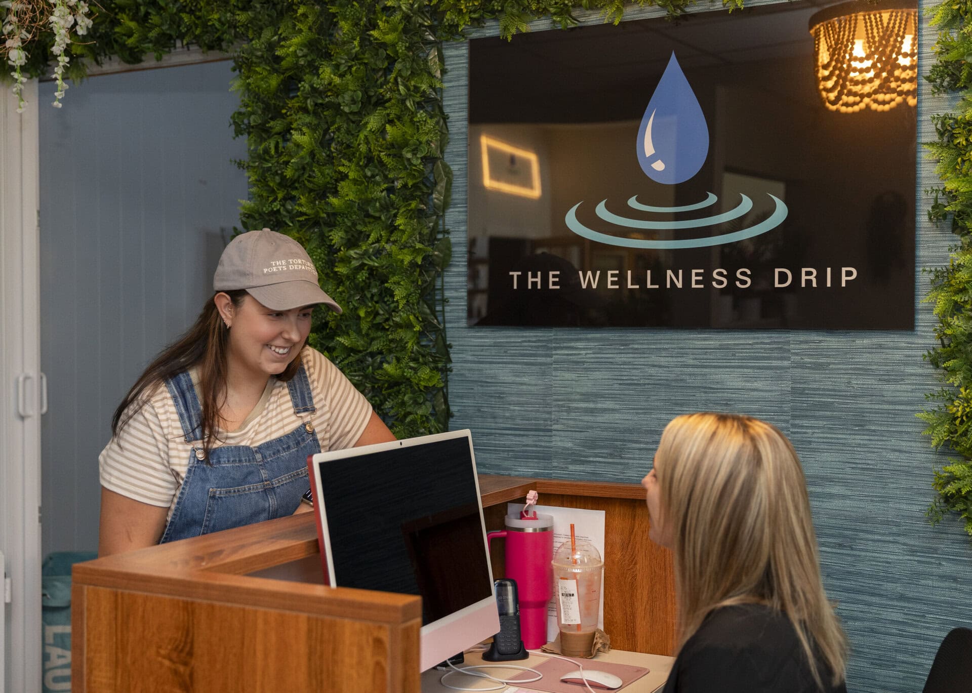 A friendly wellness staff member assisting a customer at The Wellness Drip in Holyoke with IV hydration therapy for health and vitality.
