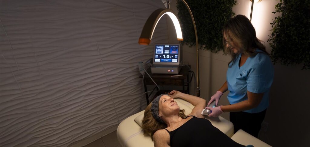 A woman receives HIFU therapy treatment from a healthcare professional at Wellness Drip Holyoke, a premier wellness center offering non Invasive Fat Reduction and Weight Loss
