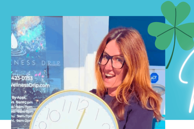 Woman holding a clock with a bright smile, promoting spring wellness, energy boost, and cellular recovery services at Wellness Drip Holyoke during March 2026.